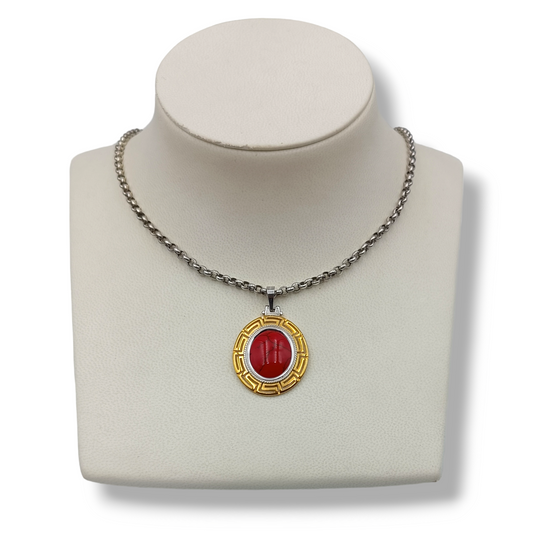 Silver two-toned Meander design pendant with red Coral stone